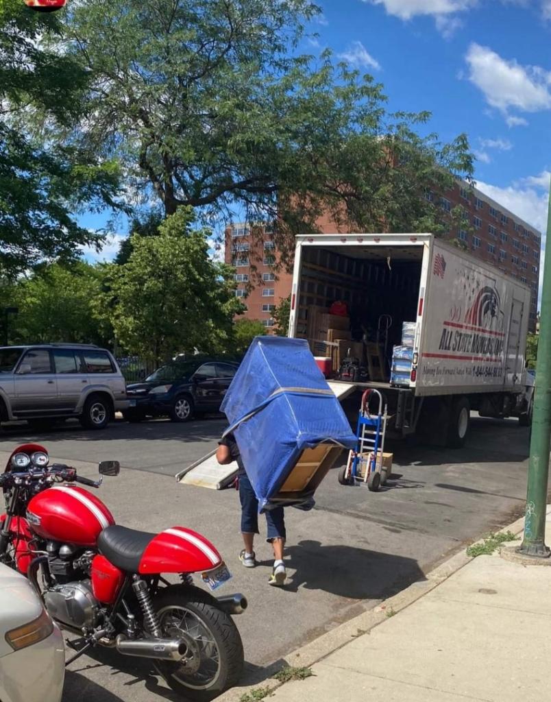 Mover uses hump strap to carry a large item that would have been too cumbersome without it