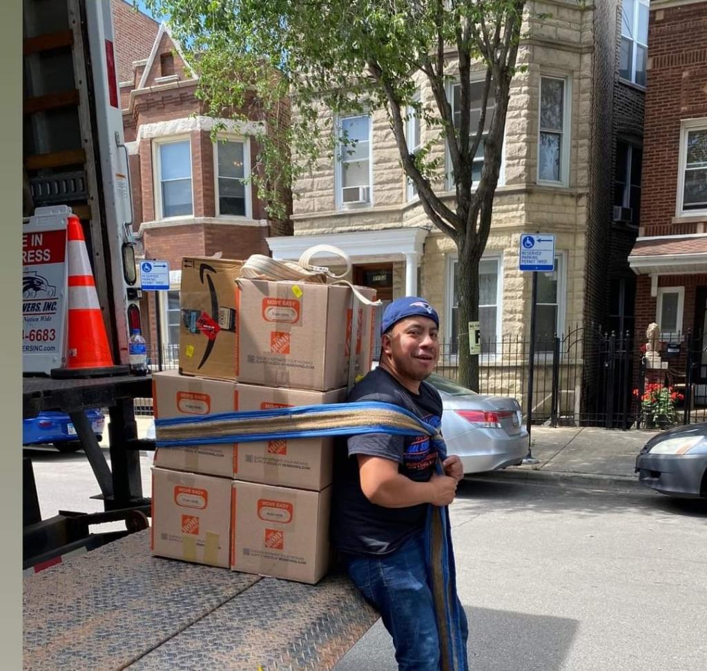 A mover uses a hump strap to carry multiple boxes